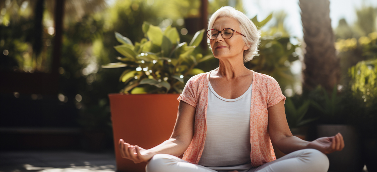 Mature woman using mindful meditation to help manage tinnitus symptoms